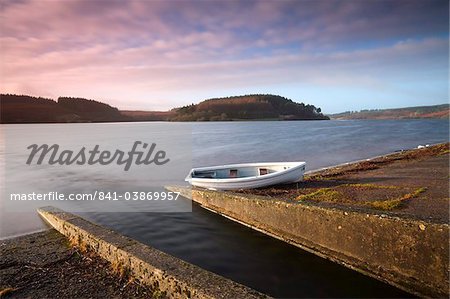 Usk reservoir outflow and boat, in winter, Brecon Beacons National Park, Wales, United Kingdom, Europe
