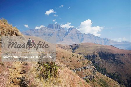 People hiking in Monk's Cowl Nature Reserve with Champagne Castle in background, Ukhahlamba-Drakensberg Park, UNESCO World Heritage Site, KwaZulu-Natal, South Africa, Africa People hiking in Monk's Cowl Nature Reserve with Champagne Castle in background, Ukhahlamba-Drakensberg Park, UNESCO World Heritage Site, KwaZulu-Natal, South Africa, Africa