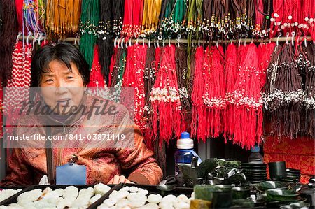 Saleswoman at coral and stone shop, Panjiayuan flea market, Chaoyang District, Beijing, China, Asia Saleswoman at coral and stone shop, Panjiayuan flea market, Chaoyang District, Beijing, China, Asia