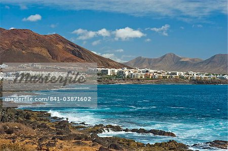 The rocky west extremity of the sea front at the popular resort of Playa Blanca on the far south coast, Playa Blanca, Lanzarote, Canary Islands, Spain, Atlantic, Europe