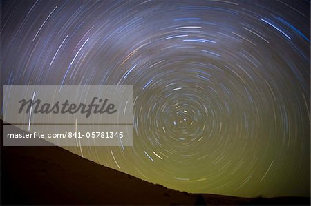 Star trails captured using an exposure time of two hours to record the rotation of the earth on its Polar Axis, stars are rotating around the Pole Star (Polaris), the Sahara Desert near Merzouga, Morocco, North Africa, Africa