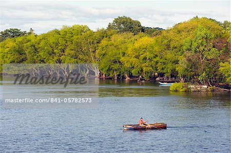 Man rowing a boat on Ometepe Island, Lake Nicaragua, Nicaragua, Central America