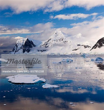 Penguins drifting on an iceberg through the Gerlache Straight, Antarctica, Polar Regions