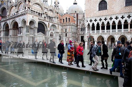 Tourists walking on footbridges during high tide in St. Mark's Square, Venice, UNESCO World Heritage Site, Veneto, Italy, Europe