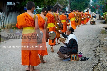 Procession of Buddhist monks collecting alms and rice at dawn, Luang Prabang, Laos, Indochina, Southeast Asia, Asia
