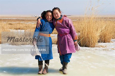 Young Mongolian girls in traditional costume (deel), Province of Khovd, Mongolia, Central Asia, Asia