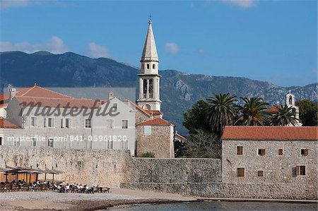 Budva fortified old town on the Adriatic coast with the tower of St. John's Church and Budva beach, Budva, Montenegro, Europe
