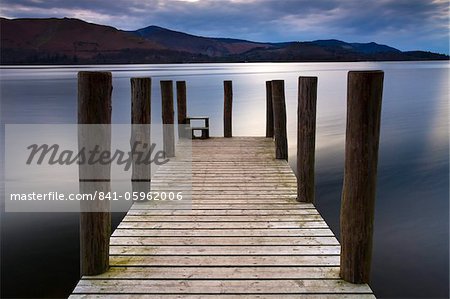 A wooden jetty stretches out into Derwent Water in the Lake District National Park, Cumbria, England, United Kingdom, Europe