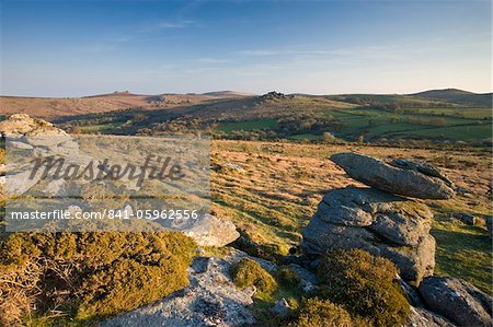 Granite outcrops in Dartmoor National Park, looking across to Hound Tor and Hay Tor on the horizon, Devon, England, United Kingdom, Europe