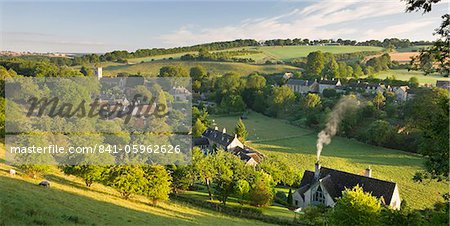 Cottages nestled into the valley in the picturesque Cotswolds village of Naunton, Gloucestershire, England, United Kingdom, Europe