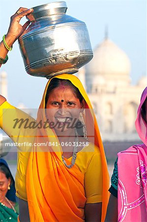 Woman carrying water pot on her head in front of the Taj Mahal, UNESCO World Heritage Site, Agra, Uttar Pradesh state, India, Asia