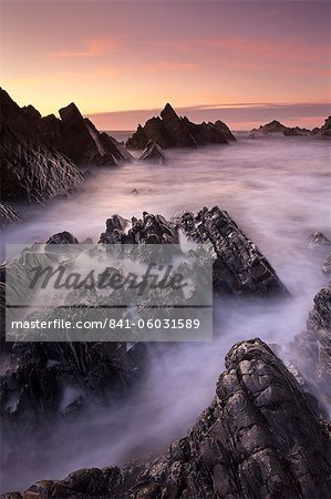 Broken rock ledges at Hartland Quay at sunset, North Devon, England, United Kingdom, Europe