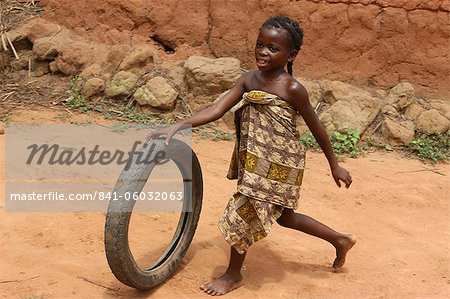 Child playing with a tyre, Tori, Benin, West Africa, Africa