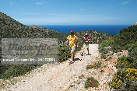 Walkers on coastal walk, Akrotiri Peninsula, Chania region, Crete, Greek Islands, Greece, Europe