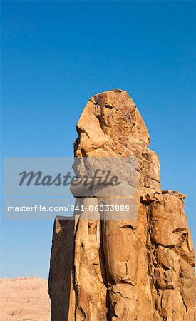 One of the Colossi of Memnon with the Theban hills behind, Thebes, UNESCO World Heritage Site, Egypt, North Africa, Africa