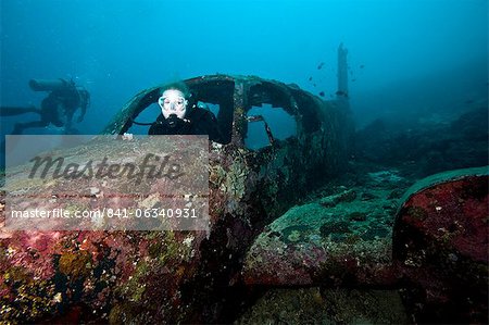 Diver inside the wreck of a four seater airplane, Philippines, Southeast Asia, Asia