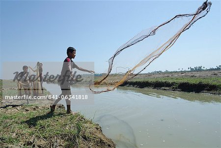 Youngsters fishing with net in waterway, Irrawaddy Delta, Myanmar (Burma), Asia