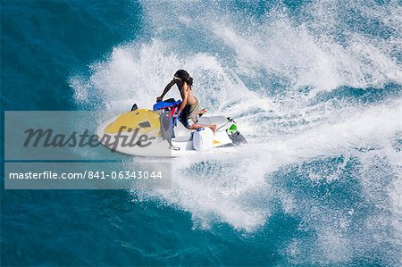 Man on a jet ski, Nassau harbor, New Providence Island, Bahamas, West Indies, Central America