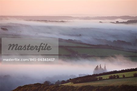 Early morning mist over the Exmoor countryside, viewed from Dunkery Hil, Exmoor National Park, Somerset, England, United Kingdom, Europe