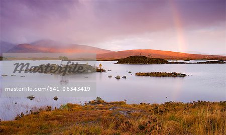 Rainbow in stormy skies over Lochan Na H-Achlaise on Rannoch Moor in Autumn, Highlands, Scotland, United Kingdom, Europe