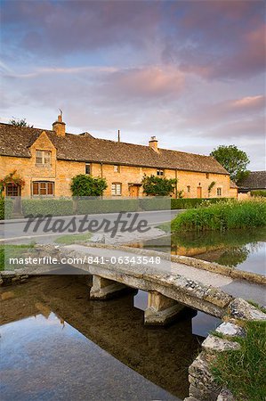 Footbridge and cottages in the picturesque Cotswold village of Lower Slaughter, Gloucestershire, The Cotswolds, England, United Kingdom, Europe