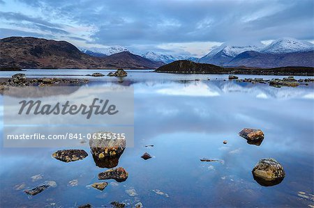 Snow covered mountains at dawn, Lochan na h Achlaise, Rannoch Moor, Argyll and Bute, Highlands, Scotland