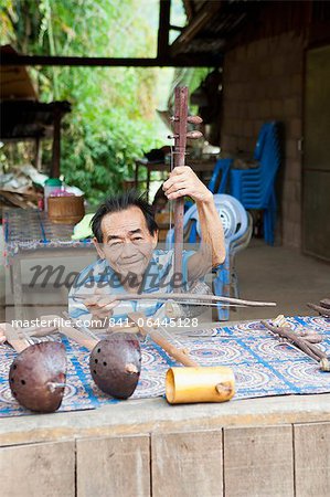 Man playing handmade musical instrument seller, Luang Prabang, Laos, Indochina, Southeast Asia, Asia