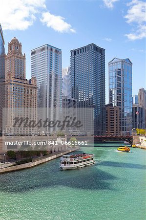 Tourist boat on the Chicago River with glass towers behind on West Wacker Drive, Chicago, Illinois, United States of America, North America