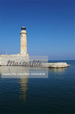 The Venetian era harbour walls and lighthouse at the Mediterranean port of Rethymnon, Crete, Greek Islands, Greece, Europe
