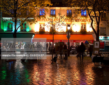 Restaurants and cafes lit at night in the Montmartre area of Paris, France, Europe