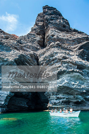 Tourist boat in front of a sea cave at Isla Espiritu Santo, Baja California, Mexico, North America