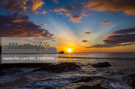 Sunset by the southern headland of beautiful Playa Pelada beach, Nosara, Nicoya Peninsula, Guanacaste Province, Costa Rica