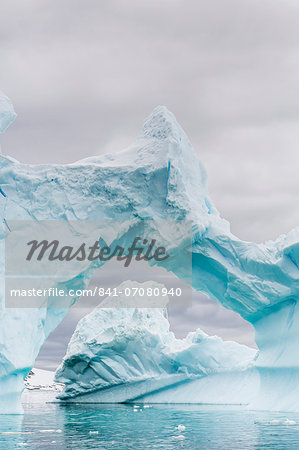 Huge arched iceberg near Petermann Island, western side of the Antarctic Peninsula, Southern Ocean, Polar Regions