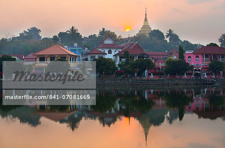 View of Kengtung (Kyaingtong) looking across Naung Tung Lake at sunrise towards the town and gilded stupa of Wat Jong Kham, Kengtung, Shan State, Myanmar (Burma), Asia View of Kengtung (Kyaingtong) looking across Naung Tung Lake at sunrise towards the town and gilded stupa of Wat Jong Kham, Kengtung, Shan State, Myanmar (Burma), Asia