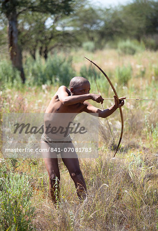 San (Bushman) demonstrating traditional hunting technique with bow and arrow at the Okahandja Cultural Village, near Okahandja town, Namibia