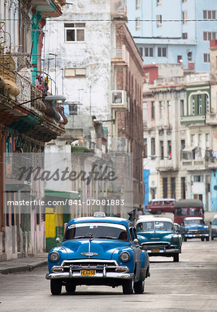 Vintage American cars used as local taxis, driving down Avenue Colon during afternoon rush hour, Havana Centro, Havana, Cuba, West Indies, Central America