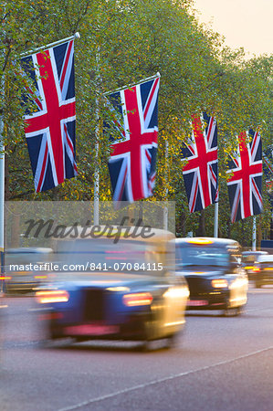 Black cabs along The Mall with Union Jack flags, London, England, United Kingdom, Europe