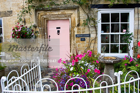 Cotswolds cottage and fenced front garden, Burford, Oxfordshire, UK