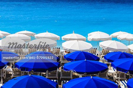Beach parasols, Nice, Alpes Maritimes, Provence, Cote d'Azur, French Riviera, France, Europe Beach parasols, Nice, Alpes Maritimes, Provence, Cote d'Azur, French Riviera, France, Europe