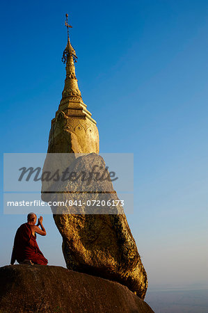 Buddhist monk praying at the Golden Rock of Nwa La Bo, Mawlamyine (Moulmein), Mon State, Myanmar (Burma), Asia