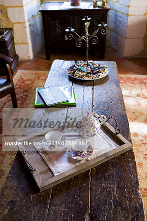 Tea tray with teapot and floral china cups in hotel, Hostellerie Les Griffons, Bourdeilles, North Dordogne, France