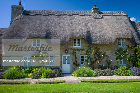 Quaint traditional thatched cottage in Minster Lovell in The Cotswolds, Oxfordshire, UK