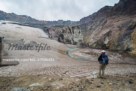 Tourist standing on a glacierfield on Mutnovsky volcano, Kamchatka, Russia, Eurasia
