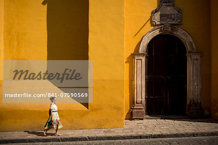 Woman walking along street, San Miguel de Allende, Guanajuato, Mexico, North America
