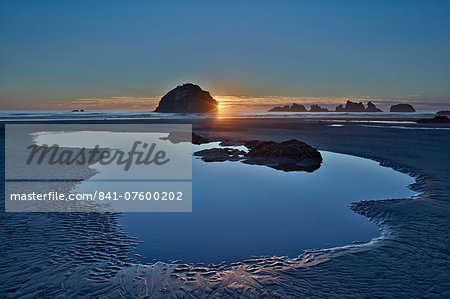 Sunset by a sea stack over a pool on the beach, Bandon Beach, Oregon, United States of America, North America Sunset by a sea stack over a pool on the beach, Bandon Beach, Oregon, United States of America, North America