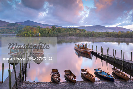 Boats moored on Derwent Water at dawn in autumn, Keswick, Lake District, Cumbria, England, United Kingdom, Europe