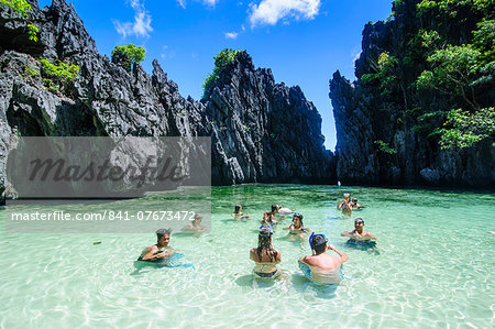 Tourists In The Hidden Bay With Crystal Clear Water In The Bacuit