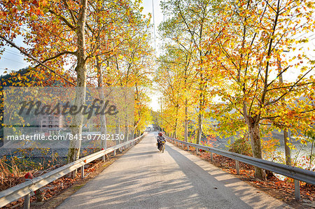 Golden autumn colors with motorbike in an alley of a village near Qiandao Lake, Zhejiang province, China.
