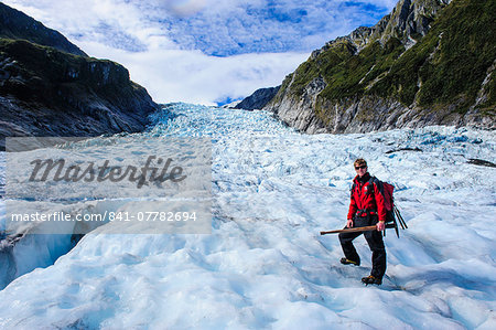 Tour guide hiking on the ice of Fox Glacier, Westland Tai Poutini National Park, South Island, New Zealand, Pacific
