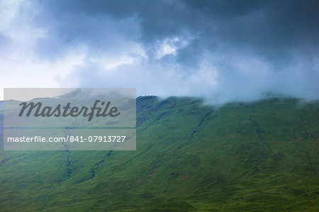 Low dark grey clouds tumbling over mountains on Isle of Mull, Inner Hebrides and Western Isles, Scotland, United Kingdom, Europe